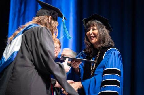 President Mantella with graduate student at commencement